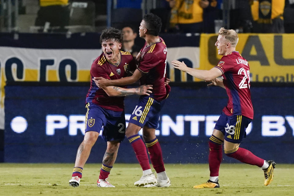 Real Salt Lake midfielder Diego Luna, left, is congratulated by midfielder Maikel Chang, middle, and defender Jasper Loffelsend, after scoring against the LA Galaxy during the second half of an MLS soccer match Saturday, Oct. 14, 2023, in Carson, Calif. (AP Photo/Ryan Sun)