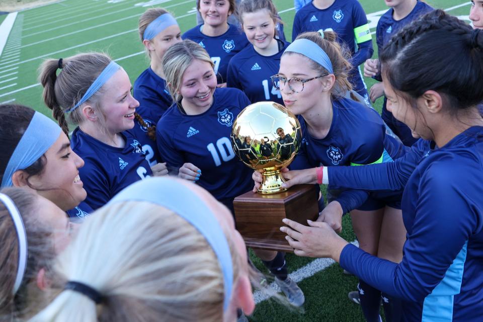 West Plains’  celebrates with the trophy in a 4A Area Round Playoff game against Estacado, Tuesday, March 28, 2023, at Happy State Bank Stadium in Canyon, Texas.  West Plains won 3-0.