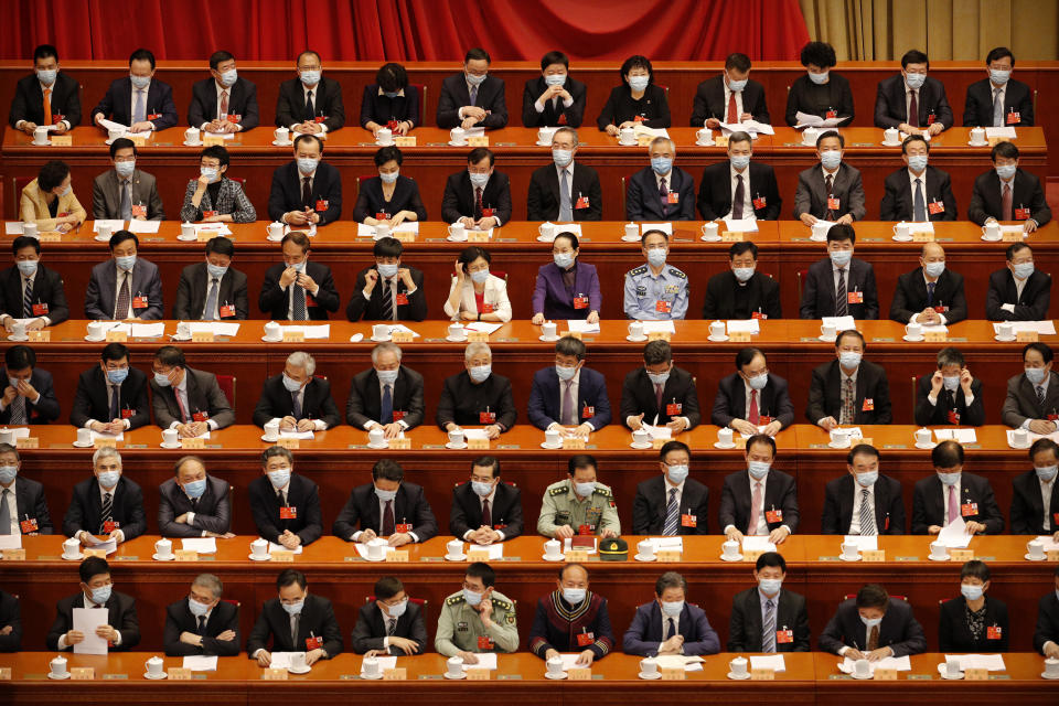 Delegates wearing face masks to protect against the spread of the new coronavirus wait for the start of the opening session of the Chinese People's Political Consultative Conference (CPPCC) at the Great Hall of the People in Beijing, Thursday, May 21, 2020. (AP Photo/Andy Wong, Pool)