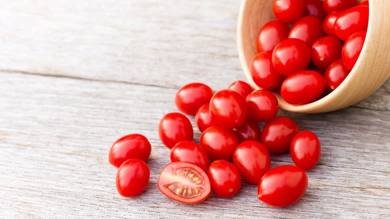 Cherry tomatoes spilling from bowl