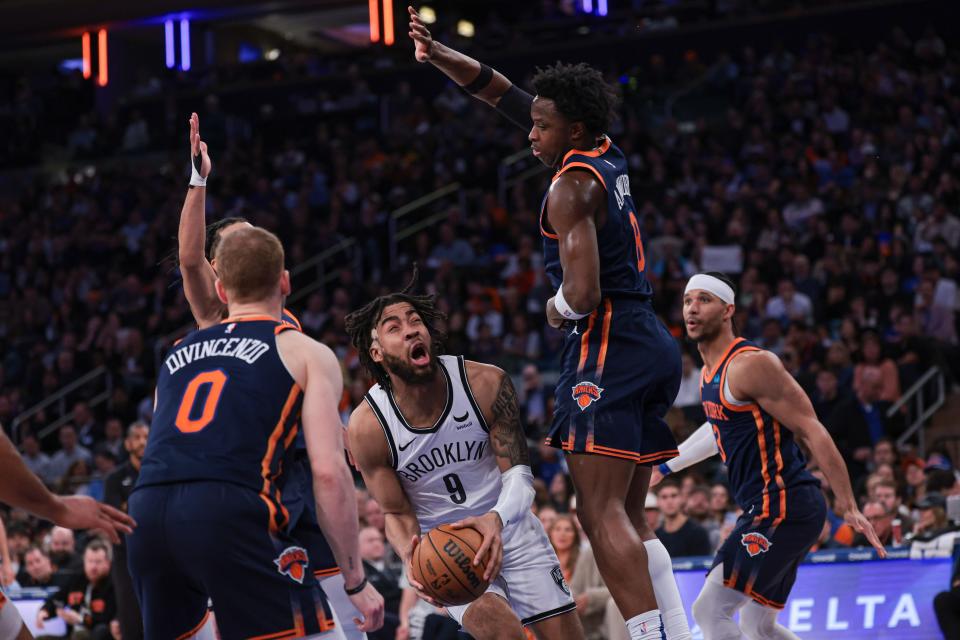 Apr 12, 2024; New York, New York, USA; Brooklyn Nets forward Trendon Watford (9) reacts after being fouled during the first half in front of New York Knicks forward OG Anunoby (8) and guard Donte DiVincenzo (0) at Madison Square Garden. Mandatory Credit: Vincent Carchietta-USA TODAY Sports