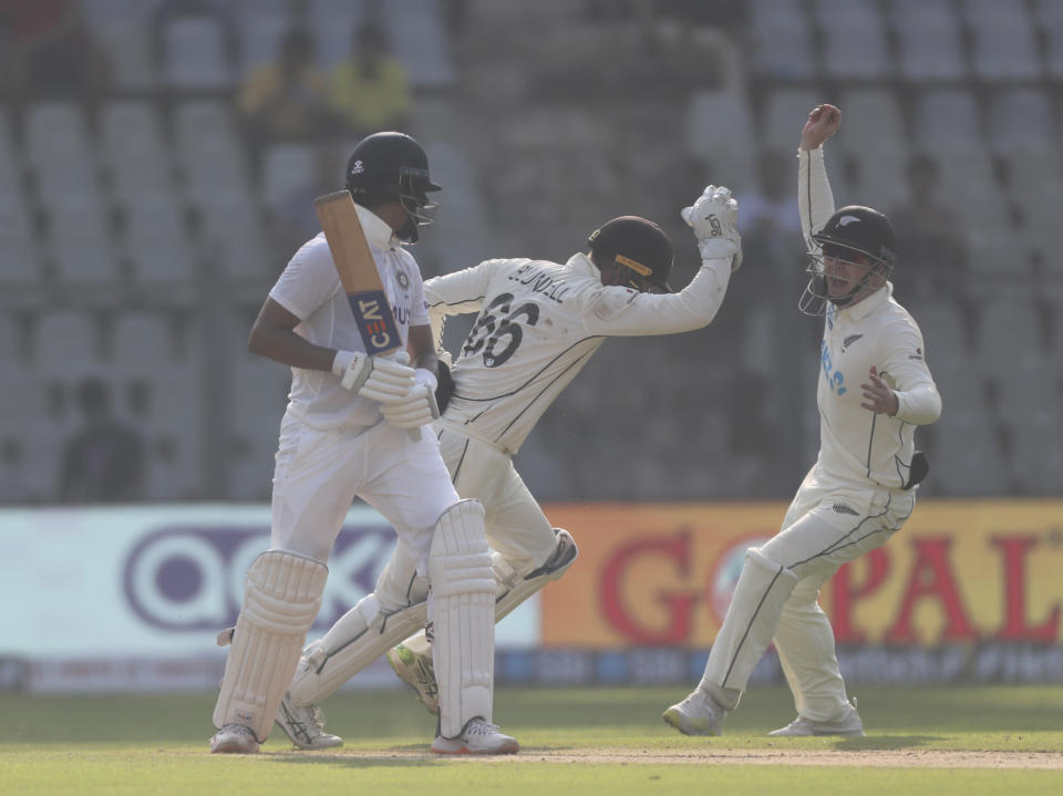 New Zealand players celebrates the dismissal of India's Shreyas Iyer, left, during the day one of second test cricket match against India in Mumbai, India, Friday, Dec. 3, 2021.(AP Photo/Rafiq Maqbool)