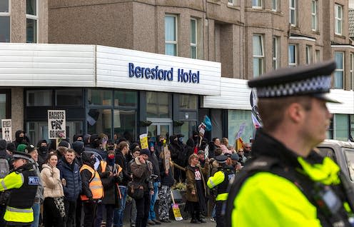 <span class="caption">The hotels housing asylum seekers have become sites of protest.</span> <span class="attribution"><a class="link " href="https://www.shutterstock.com/image-photo/newquay-cornwall-0225-beresford-hotel-protest-2267945293" rel="nofollow noopener" target="_blank" data-ylk="slk:JMundy/Shutterstock;elm:context_link;itc:0;sec:content-canvas">JMundy/Shutterstock</a></span>