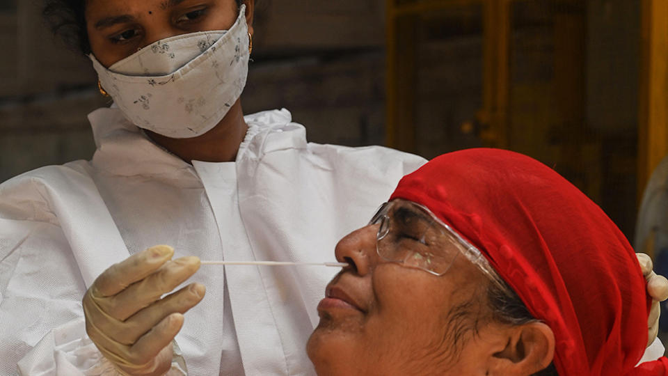 A medical staff takes a nasal swab for a Rapid Antigen Testing (RAT) test amidst rising Covid-19 coronavirus cases, in Mumbai on April 19, 2021