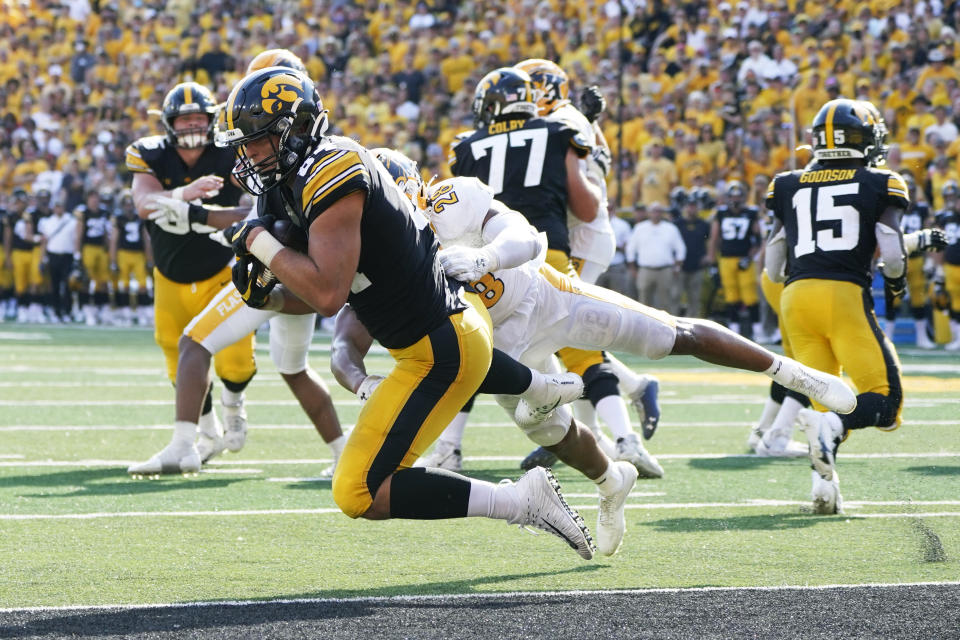 Iowa tight end Sam LaPorta (84) catches a 5-yard touchdown pass ahead of Kent State linebacker Mandela Lawrence-Burke (28) during the first half of an NCAA college football game, Saturday, Sept. 18, 2021, in Iowa City, Iowa. (AP Photo/Charlie Neibergall)