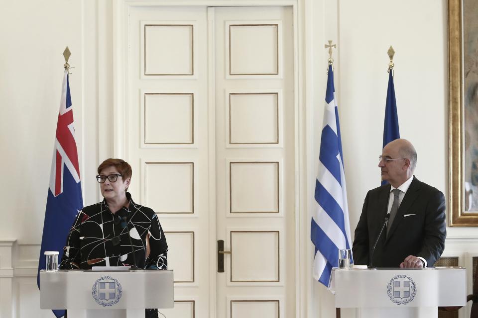 Australian Foreign Minister Marise Payne, left, makes statements after a meeting with her Greek counterpart Nikos Dendias, right, in Athens, Greece, Wednesday, Dec. 8, 2021. The foreign minister of Australia, launching a European tour in Athens Wednesday, welcomed a recent initiative by the European Union to boost its presence in the Indo-Pacific region despite a spat with EU member France over the cancelation of a massive submarine order. (Panayotis Tzamaros/InTime News via AP)