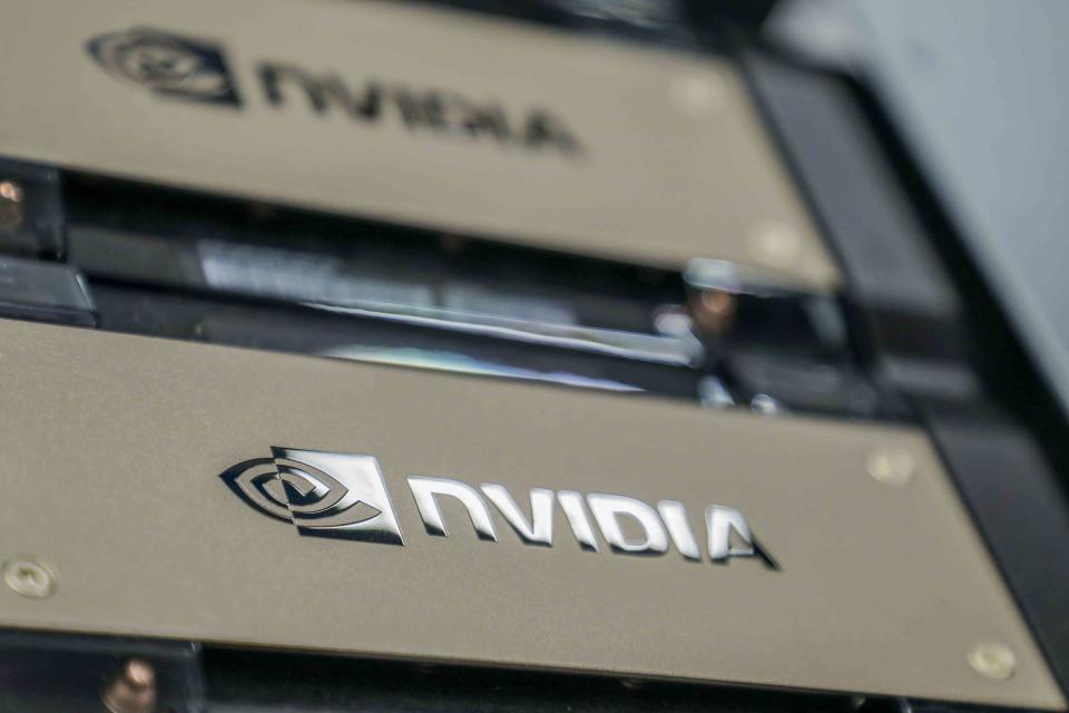 <p>Dhiraj Singh / Bloomberg / Getty Images</p> Nvidia technology in a server room.