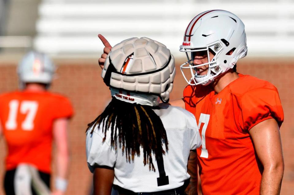 Mercer quarterback Carter Peevy (7) speaks with receiver Devron Harper (1) during a team practice August 15. The Bears open the season against N. Alabama in Montgomery August 26.