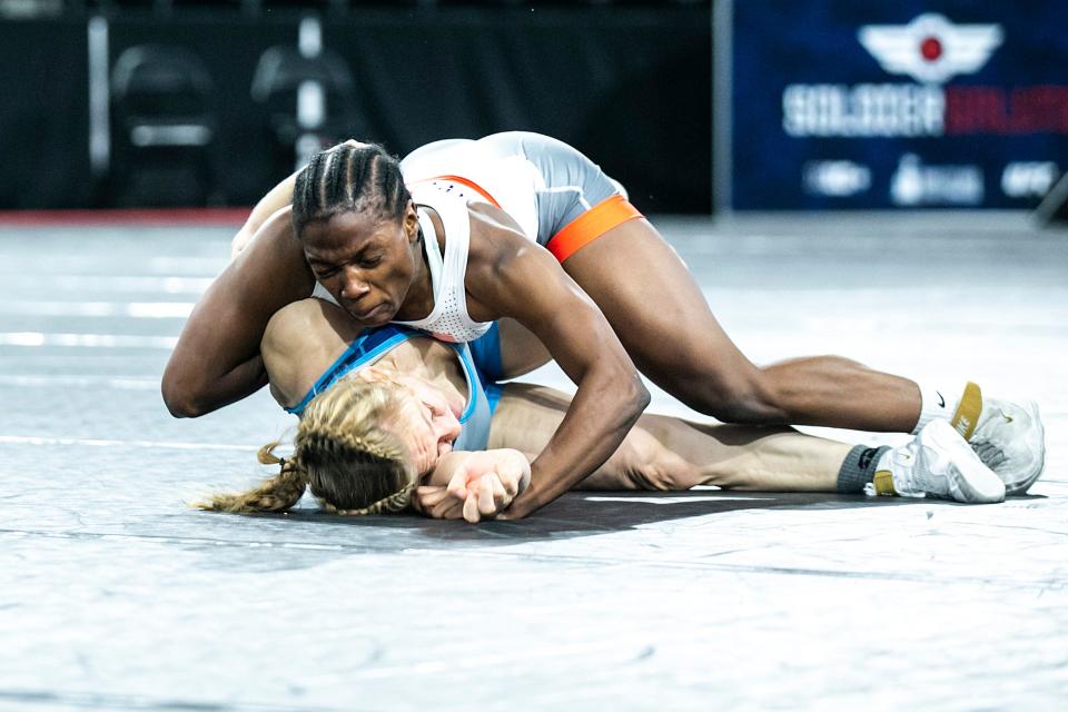 Iowa Wesleyan's Adaugo Nwachukwu, top, wrestles Army WCAP's Bridgette Duty at 136 pounds in the finals of the Soldier Salute college wrestling tournament Dec. 30, 2022, at Xtream Arena in Coralville.