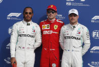 Ferrari driver Charles Leclerc of Monaco, who clocked the fastest time, poses between runner-up Mercedes driver Lewis Hamilton of Britain and third fastest Mercedes driver Valtteri Bottas of Finland, after the qualifying session at the Monza racetrack, in Monza, Italy, Saturday, Sept. 7, 2019. The Formula one race will be held on Sunday. (AP Photo/Antonio Calanni)