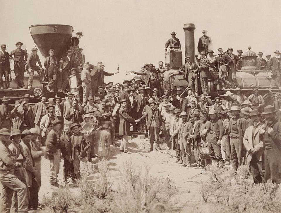 A.J. Russell image of the celebration following the driving of the "Last Spike" at Promontory Summit, Utah, May 10, 1869. Because of <a href="https://en.wikipedia.org/wiki/Temperance_movement">temperance</a> feelings the liquor bottles held in the center of the picture were removed from some later prints. (Photo: Andrew J Russell/Beinecke Library/Yale University)