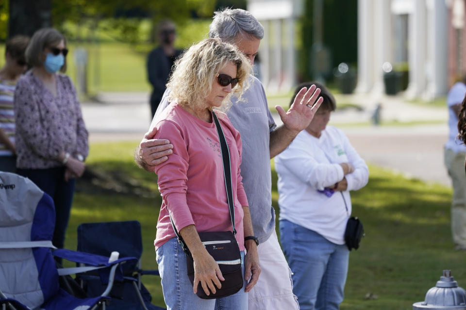 People pray during a vigil at the Collierville Town Hall Friday, Sept. 24, 2021, in Collierville, Tenn. The vigil is for the person killed and those injured when a gunman attacked people in a Kroger grocery store Thursday before he was found dead of an apparent self-inflicted gunshot wound. (AP Photo/Mark Humphrey)