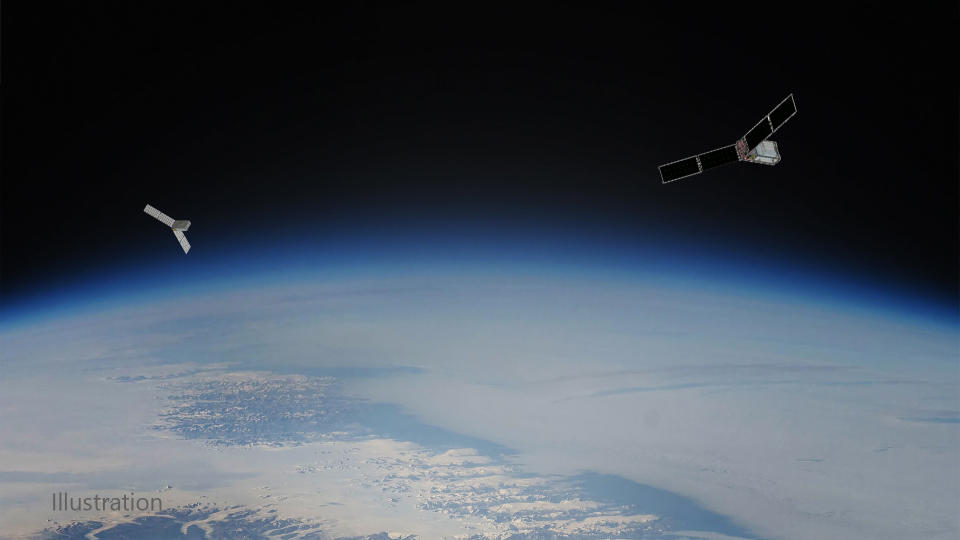 a depiction of two small T-shaped satellites in orbit above Earth.  The Arctic can be seen below