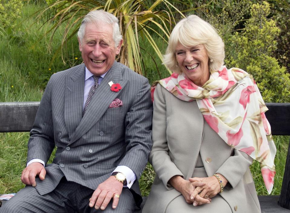 King Charles and Camilla, Queen Consort laugh and dodge a bee.