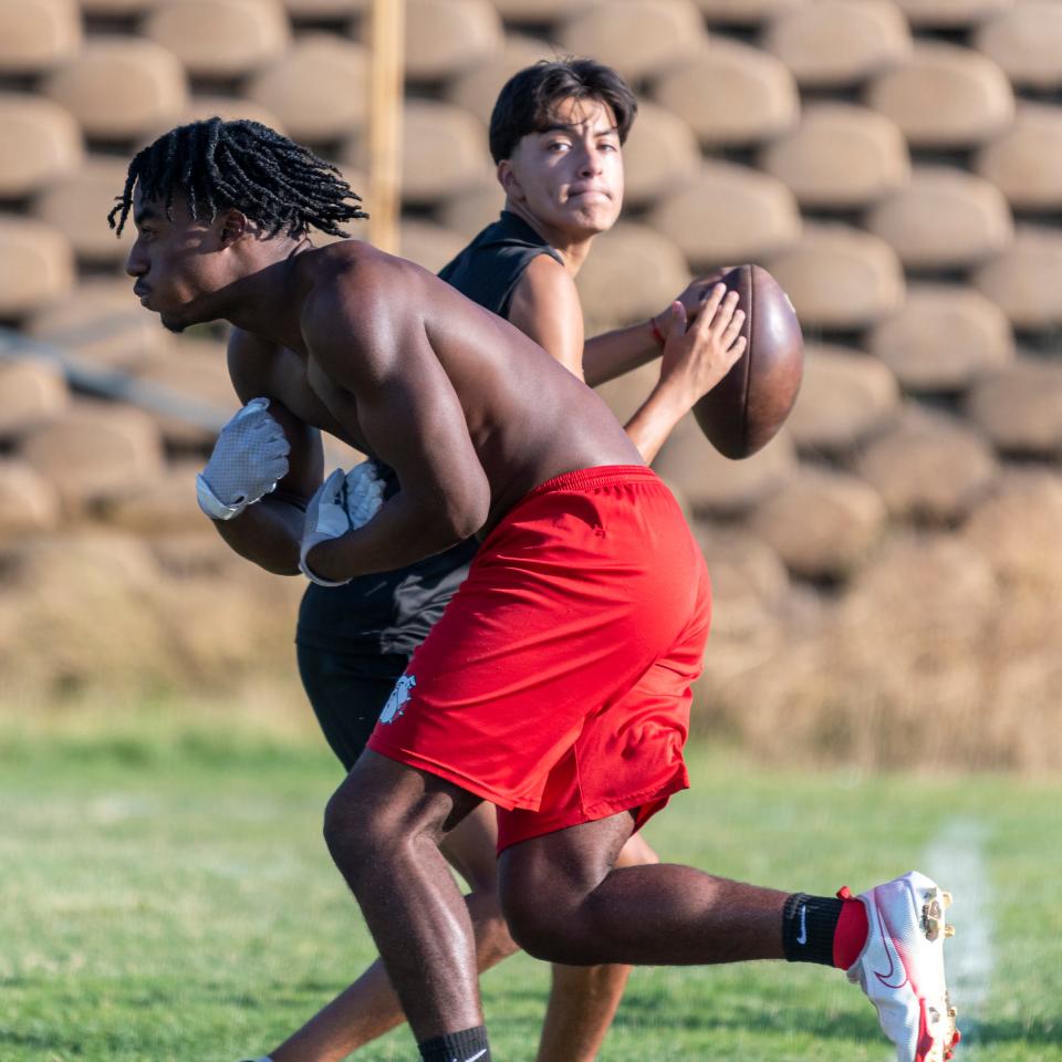 Oak Hills quarterback Diego Lopez looks to pass during a recent practice at the school.