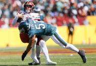 Philadelphia Eagles linebacker T.J. Edwards (57) hits Washington Commanders quarterback Carson Wentz (11) during the first half of an NFL football game, Sunday, Sept. 25, 2022 in Landover, Md. (Shaban Athuman/Richmond Times-Dispatch via AP)