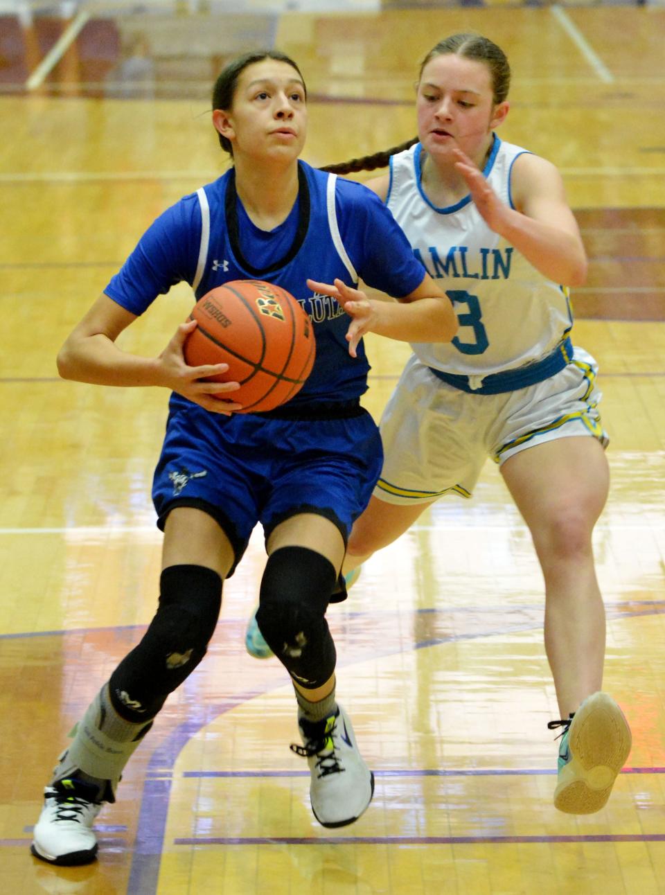 Red Cloud's Ashlan Blount drives against Hamlin's Addie Neuendorf during their semifinal game in the state Class A high school girls basketball tournament on Friday, March 10, 2023 in the Watertown Civic Arena.
