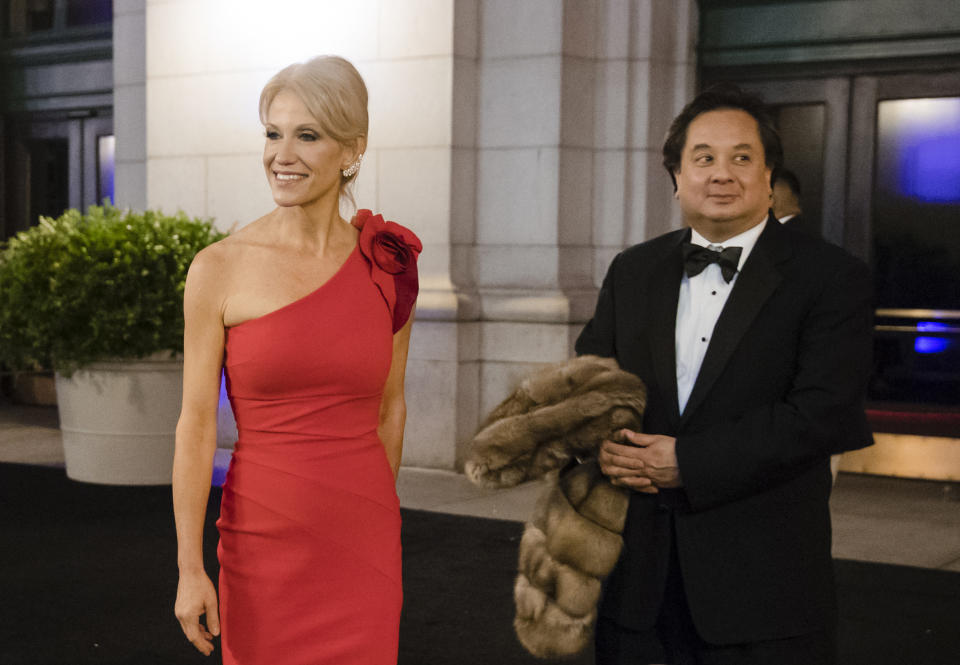 FILE - President-elect Donald Trump adviser Kellyanne Conway accompanied by her husband, George, speaks with members of the media as they arrive for a dinner at Union Station on Jan. 19, 2017, in Washington, the day before Trump's inauguration. The couple posted a joint statement on their Twitter accounts Saturday, March 4, 2023, announcing they are divorcing. (AP Photo/Matt Rourke, File)