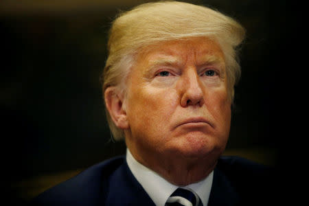 U.S. President Donald Trump listens during a round table meeting with members of law enforcement about sanctuary cities in the Roosevelt Room at the White House in Washington, U.S., March 20, 2018. REUTERS/Leah Millis