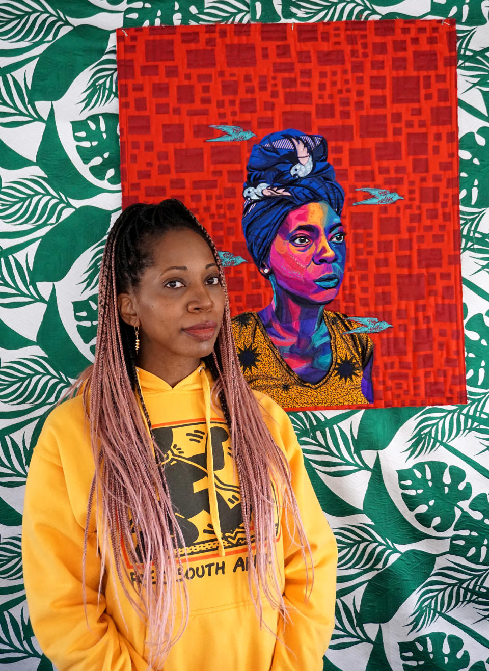 Artist Bisa Butler with her quilted portrait of Porche Bennett-Bey<span class="copyright">Courtesy Bisa Butler</span>