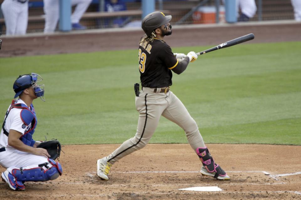 Fernando Tatis Jr. hits a solo home run for the Padres during the fourth inning of Sunday's game.