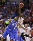 Kentucky's Andrew Harrison (5) and Louisville's Terry Rozier go after a loose ball during the first half of an NCAA Midwest Regional semifinal college basketball tournament game Friday, March 28, 2014, in Indianapolis. (AP Photo/David J. Phillip)