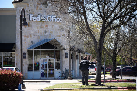 Law enforcement personnel are seen outside a FedEx Store which was closed for investigation, in Austin, Texas, U.S., March 20, 2018. REUTERS/Sergio Flores