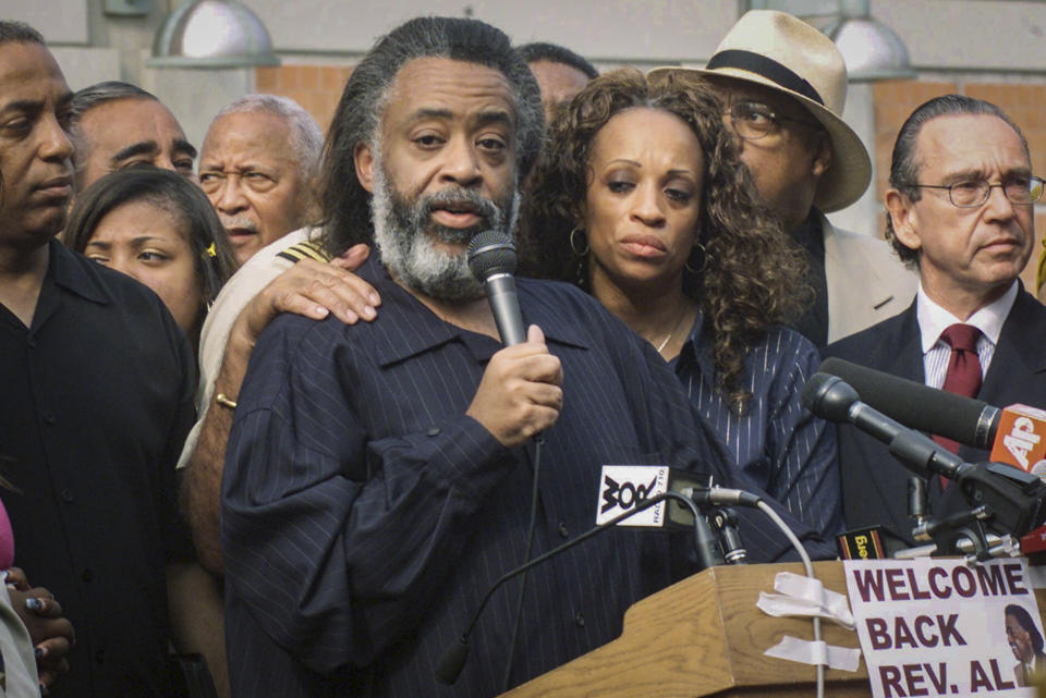 FILE - This Friday Aug. 17, 2001 file photo shows Rev. Al Sharpton, center, with his wife Kathy Jordan, third from left, as he speaks at a press conference following his released from the Metropolitan Detention Center in Brooklyn, N.Y. More than 16 years after separating, Rev. Al Sharpton has filed for divorce from his estranged wife, Kathy Jordan Sharpton. (AP Photo/Ed Bailey, File)