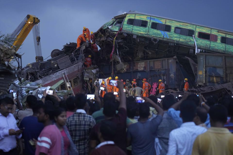 Rescuers work to take out the body of a victim of passenger trains that derailed in Balasore district, in the eastern Indian state of Orissa, Saturday, June 3, 2023. Rescuers in India have found no more survivors in the overturned and mangled wreckage of two passenger trains that derailed, killing more than 280 people and injuring hundreds in one of the country’s deadliest rail crashes in decades. (AP Photo/Rafiq Maqbool)
