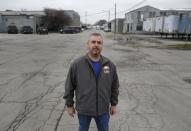 Mike Harmon, of Huntington, Ind., poses outside his union's meeting hall in Huntington, Ind., Tuesday, Dec. 6, 2016. Harmon, whose wife also works at the factory, said it's his third factory closing. He's worried he won't find anything close to the $17 an hour United Technologies provides. The couple has two children in college and two in high school and is doing what he called "major couponing" and cutting back on non-necessities. (AP Photo/Michael Conroy)