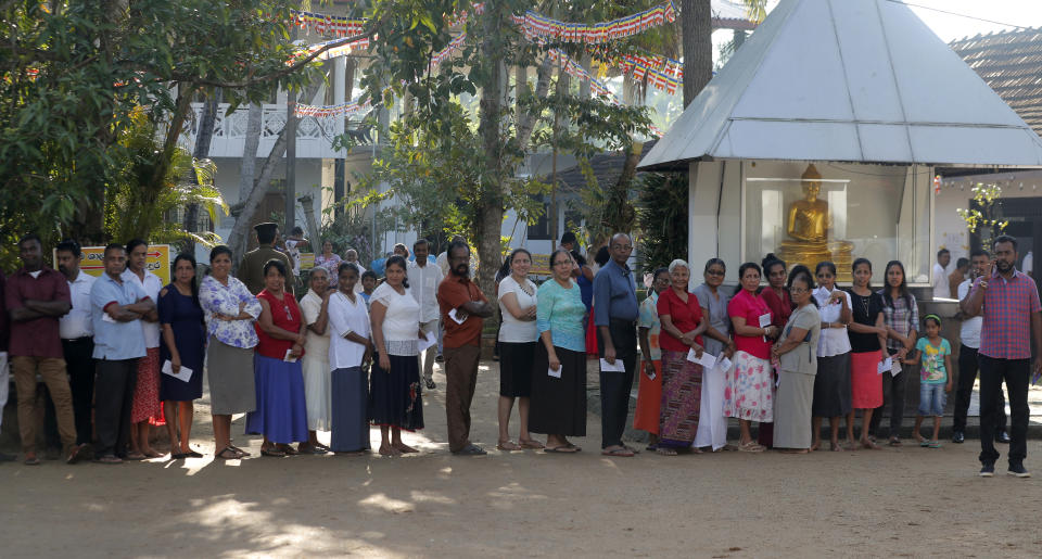 Sri Lankans wait in queue to cast their votes at a polling station during the presidential election in Colombo, Sri Lanka, Saturday, Nov. 16, 2019. Polls opened in Sri Lanka’s presidential election Saturday after weeks of campaigning that largely focused on national security and religious extremism in the backdrop of the deadly Islamic State-inspired suicide bomb attacks on Easter Sunday.(AP Photo/Eranga Jayawardena)