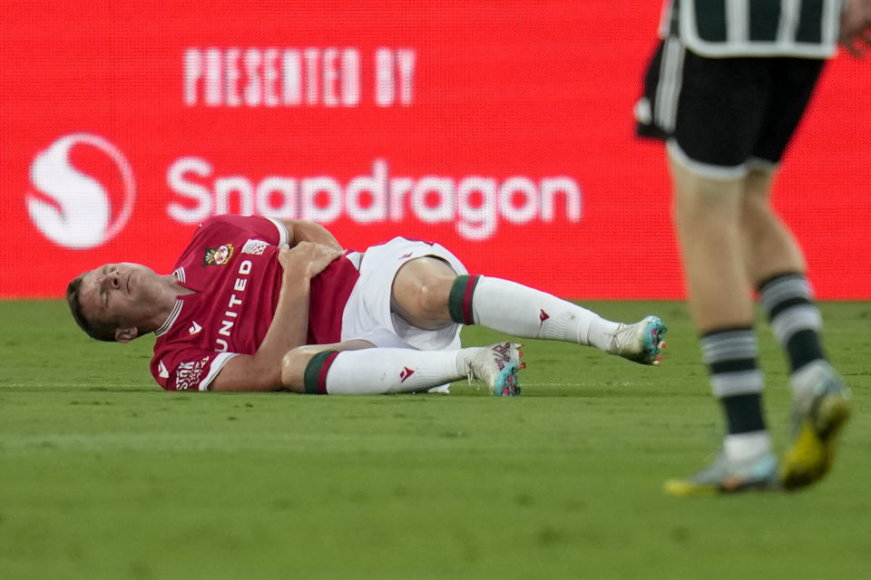 Wrexham forward Paul Mullin stays on the field after an injury during the first half of a club friendly soccer match against Manchester United, Tuesday, July 25, 2023, in San Diego. (AP Photo/Gregory Bull)