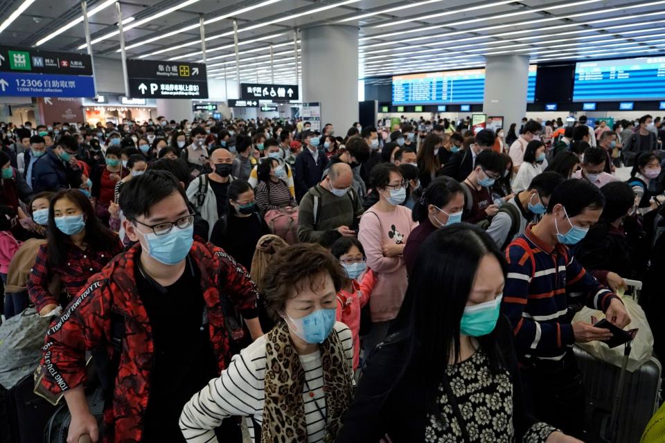 Passengers wear protective face masks at the departure hall of the high speed train station in Hong Kong: AP