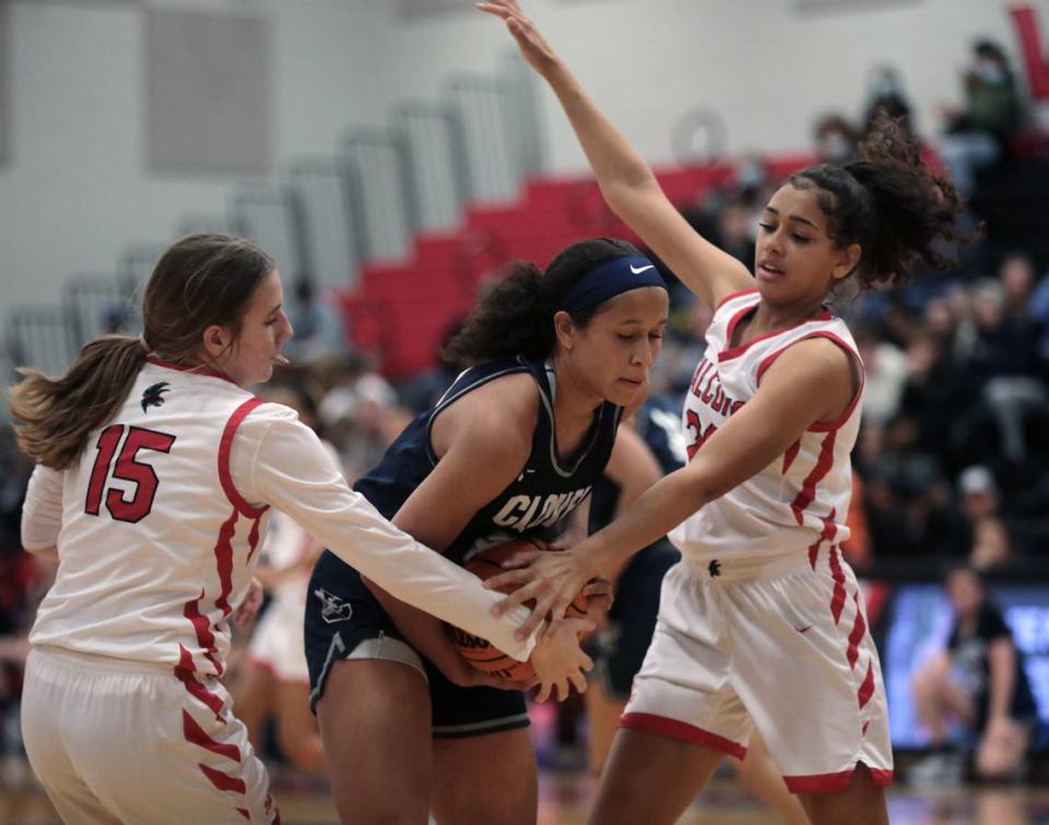 Clover’s Teagan Bertwell, center, and Nation Ford’s Sara McCaskill (15) and Waverleigh Has fight for the ball Friday as the Falcons take on the Blue Eagles in Fort Mill.