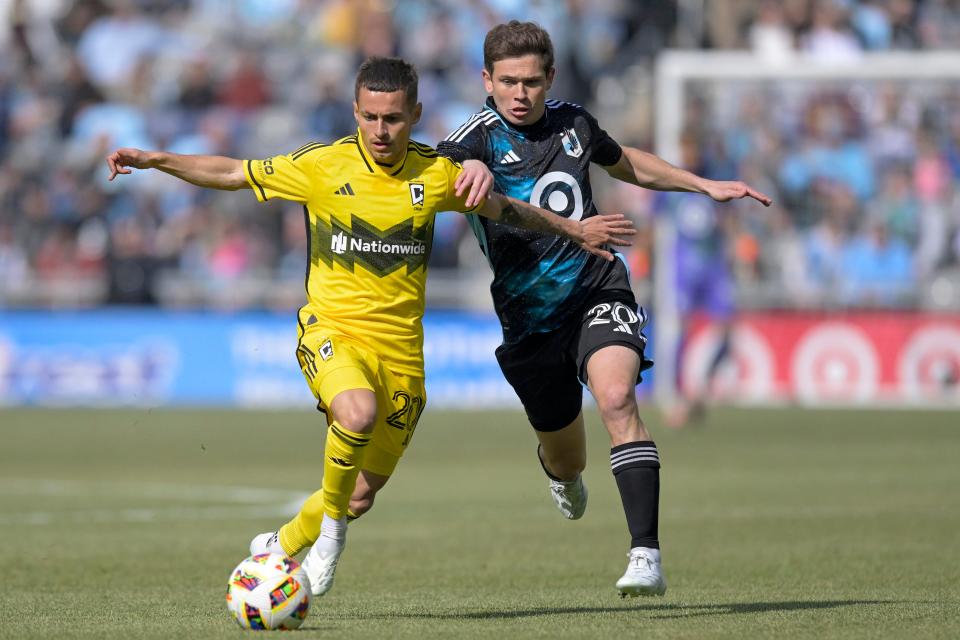 Crew midfielder Alexandru Matan battles Minnesota's Wil Trapp for the ball on Saturday.