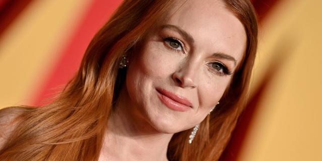 An apparently bra-less Lindsay Lohan reveals quite a bit through