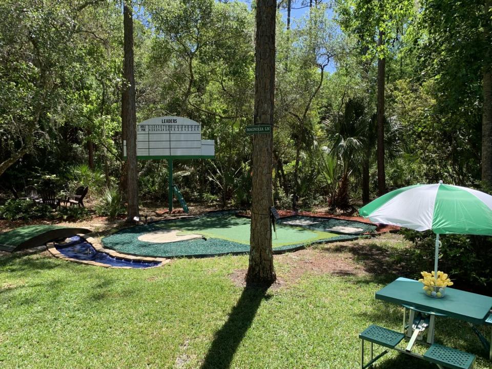 A replica of the August National scoreboard and No. 12 hole in the backyard of former pro golfer Tommy Craig.