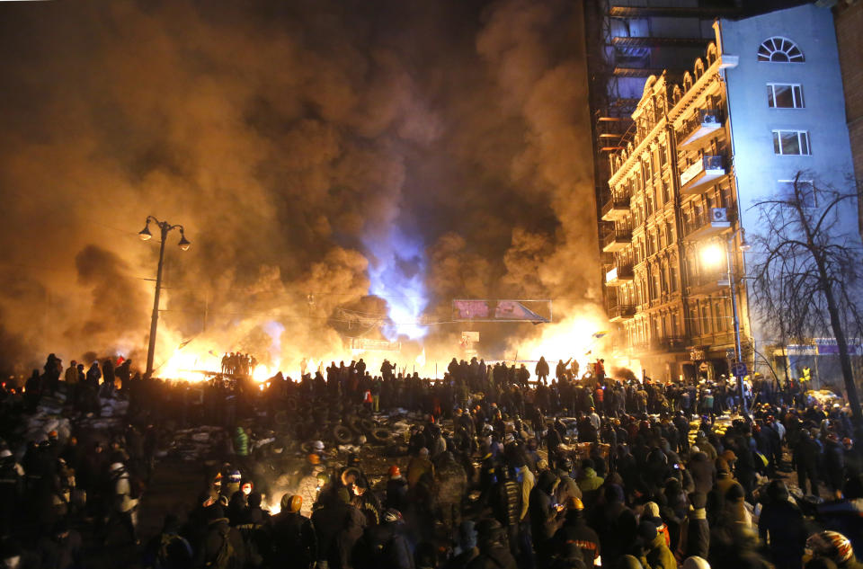 Black smoke and fireballs rise during clashes between protesters and police in central Kiev, Ukraine, early Saturday, Jan. 25, 2014. As riots spread from Ukraine's embattled capital to nearly half of the country, President Viktor Yanukovych promised Friday to reshuffle his government and make other concessions - but a top opposition leader said nothing short of his resignation would do. (AP Photo/Sergei Grits)