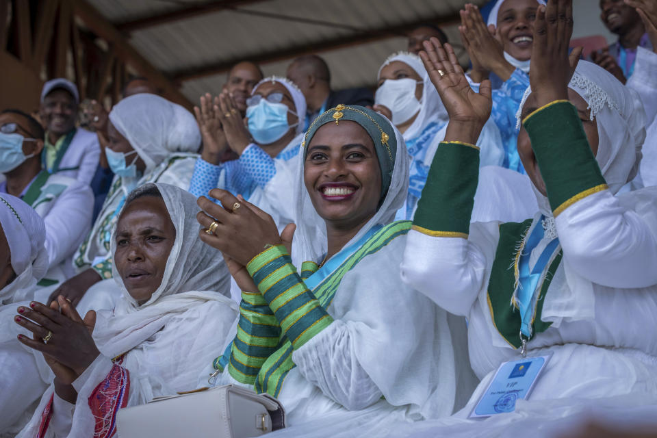 Women applaud as they sit in the stands at the final campaign rally of Ethiopia's Prime Minister Abiy Ahmed, in the town of Jimma in the southwestern Oromia Region of Ethiopia Wednesday, June 16, 2021. The country is due to vote in a general election on Monday, June, 21, 2021. (AP Photo/Mulugeta Ayene)