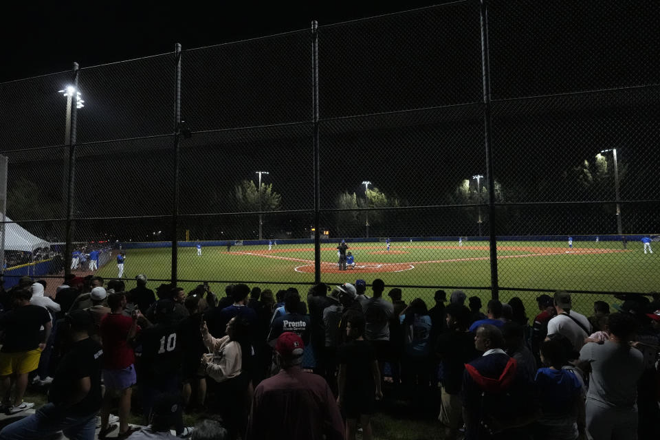 Baseball fans watch an exhibition game between the Cuban Professional Baseball Federation and Miami Dade College, Wednesday, Jan. 17, 2024, in Miami. The team is a group of about 30 or so players, most of whom were born in Cuba and defected from their home island. They’re not affiliated with the Baseball Federation of Cuba (FCB), the sport’s governing body in Cuba, but were put together to field a team that represents the patriotic ideals of their people. (AP Photo/Wilfredo Lee)