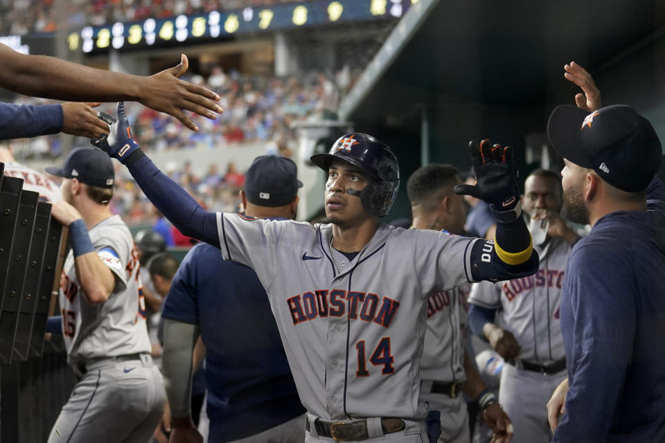 Houston Astros' Mauricio Dubon (14) celebrates in the dugout after hitting a solo home run in the sixth inning of a baseball game against the Texas Rangers, Monday, Sept. 4, 2023, in Arlington, Texas. (AP Photo/Tony Gutierrez)