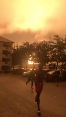 People run after a natural gas station exploded in Ghana's capital Accra, in this still image taken from October 7, 2017 social media video. MANDATORY CREDIT Jeffrey Daniel-Adoosey/via REUTERS