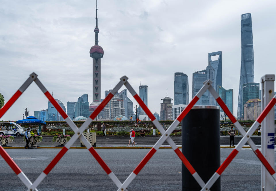 Pedestrians walk on the Bund, opposite Lujiazui Financial Center in Shanghai on June 10, 2022, as Shanghai will carry out a city wide Covid-19 testing in the coming weekend. - China OUT (Photo by LIU JIN / AFP) / China OUT (Photo by LIU JIN/AFP via Getty Images)
