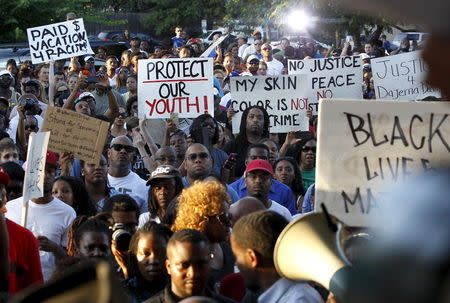 Protestors listen during a rally against what demonstrators call police brutality in McKinney, Texas June 8, 2015. REUTERS/Mike Stone