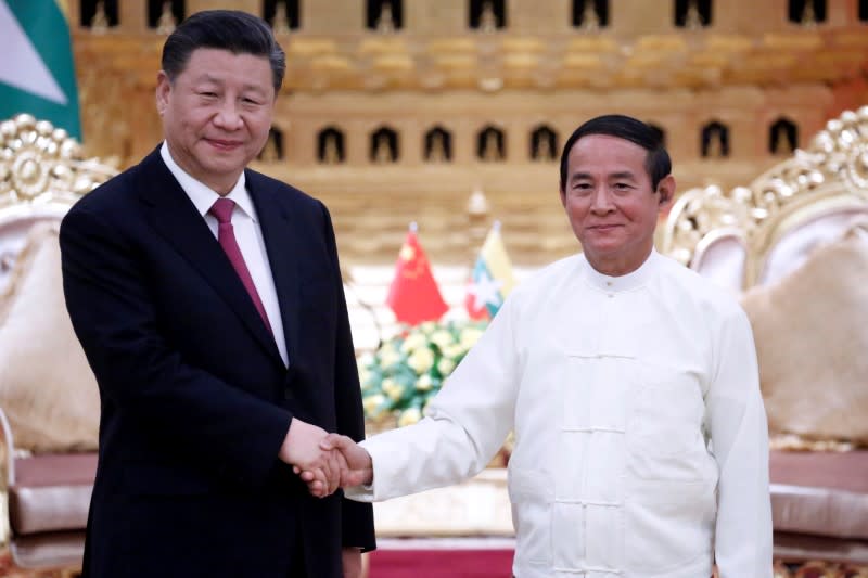 Chinese President Xi and Myanmar President Win shake hands in Naypyitaw