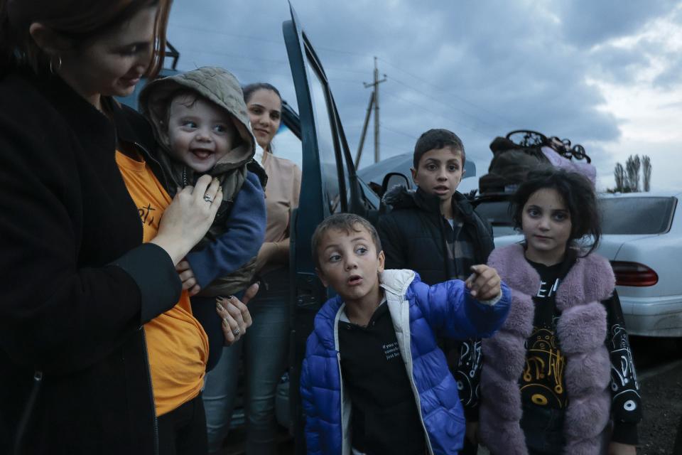 Ethnic Armenians from Nagorno-Karabakh wait to drive to Kornidzor, the town in Syunik region, Armenia, Monday, Sept. 25, 2023. Thousands of Armenians have streamed out of Nagorno-Karabakh after the Azerbaijani military reclaimed full control of the breakaway region last week. (AP Photo/Vasily Krestyaninov)