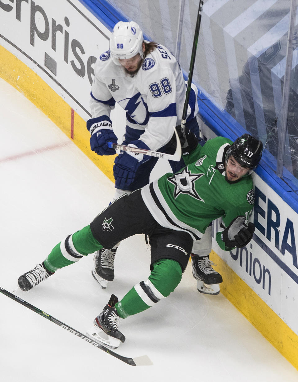 Tampa Bay Lightning defenseman Mikhail Sergachev (98) checks Dallas Stars right wing Nick Caamano (17) during the first period of Game 3 of the NHL hockey Stanley Cup Final, Wednesday, Sept. 23, 2020, in Edmonton, Alberta. (Jason Franson/The Canadian Press via AP)