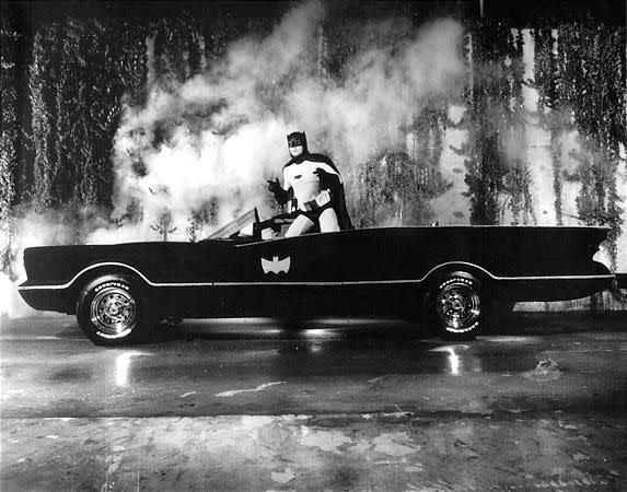 Adam West in the Batmobile on the TV show “Batman.”