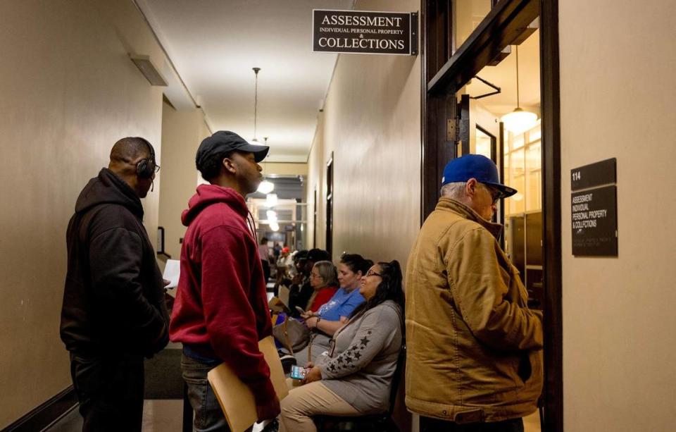 People wait in line to work with staff at the Jackson County Assessment office on Friday, March 29, 2024, in Independence, Missouri. Nick Wagner/nwagner@kcstar.com