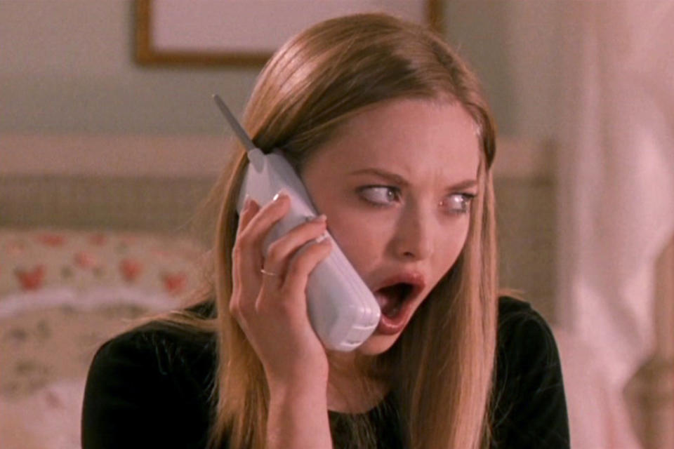 Amanda Seyfried as Karen Smith holds a phone to her ear with an astonished expression in a scene from the movie "Mean Girls"